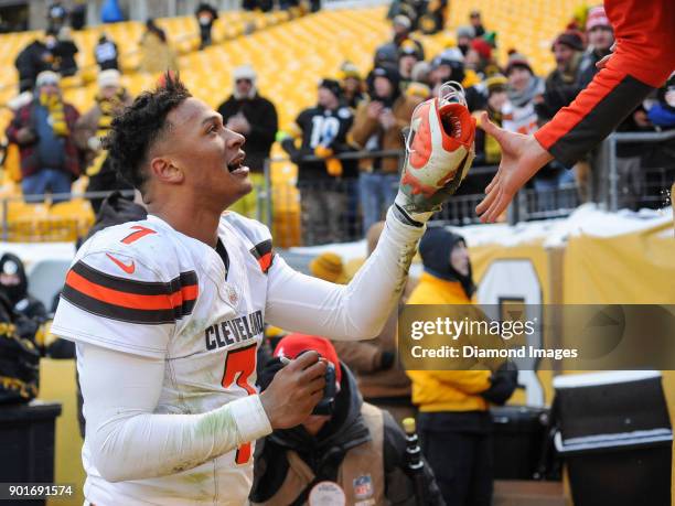 Quarterback DeShone Kizer of the Cleveland Browns hands one of his cleats to a fan after a game on December 31, 2017 against the Pittsburgh Steelers...