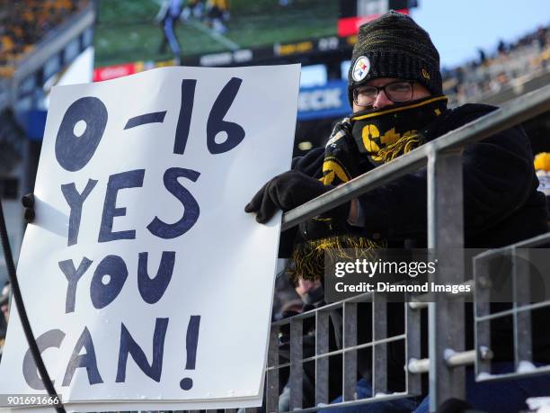 Fan of the Pittsburgh Steelers holds up a sign in the second quarter of a game on December 31, 2017 against the Cleveland Browns at Heinz Field in...