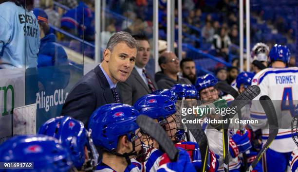 Norm Bazin head coach of the Massachusetts Lowell River Hawks stands behind the bench during NCAA men's hockey against the Vermont Catamounts at the...