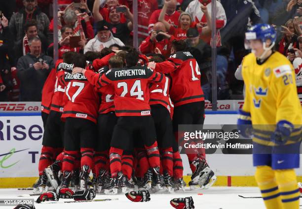 Team Canada celebrates after beating Sweden in the Gold medal game of the IIHF World Junior Championship at KeyBank Center on January 5, 2018 in...
