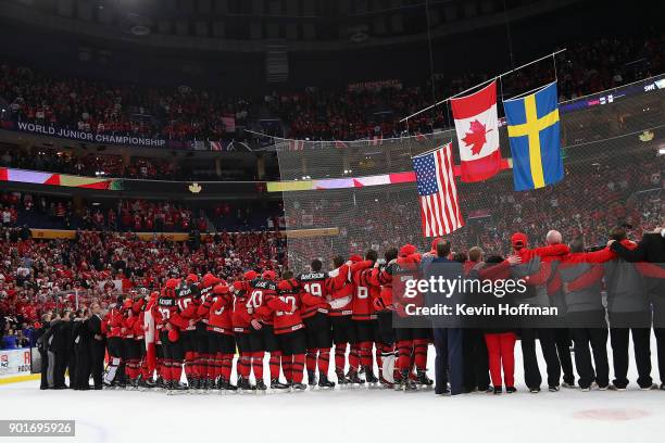 Team Canada stands together for the national anthem after the Gold medal game against Sweden of the IIHF World Junior Championship at KeyBank Center...