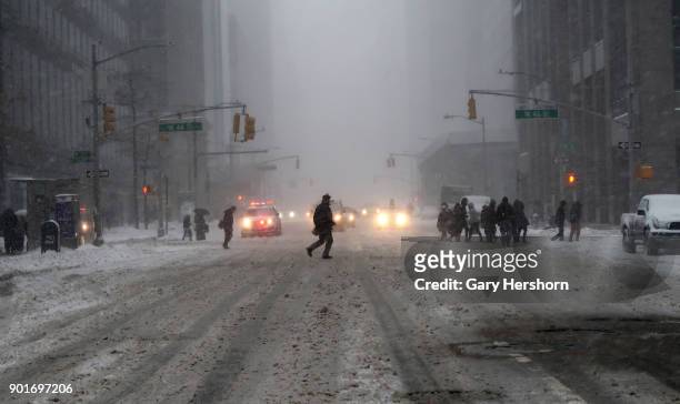 Winter storm called a "bomb cyclone" dumps snow on 6th Avenue on January 4, 2018 in New York City.