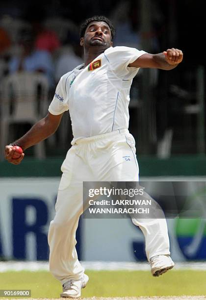 Sri Lankan cricketer Muttiah Muralitharan delivers a ball during the third day of the second Test match between Sri Lanka and New Zealand at The...
