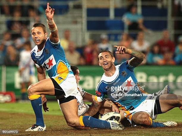 Mat Rogers and Scott Prince of the Titans appeal to the referee for a try during the round 25 NRL match between the Gold Coast Titans and the West...
