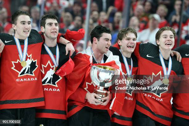 Canada Captain Dillon Dubé holds the Championship trophy and sings the Canadian National Anthem with teammates following their 3-1 win over Sweden in...