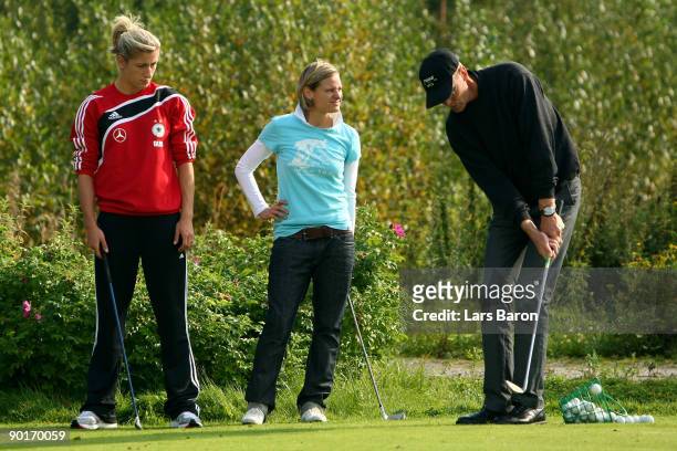Pro Kari Jarvinpaa explains Bianca Schmidt and Martina Mueller a chip during a German National Team golf session at Tammer Golfclub on August 29,...