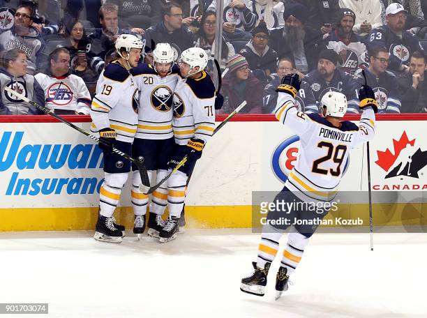 Jason Pominville of the Buffalo Sabres joins teammates Jake McCabe, Scott Wilson and Evan Rodrigues as they celebrate a third period goal against the...