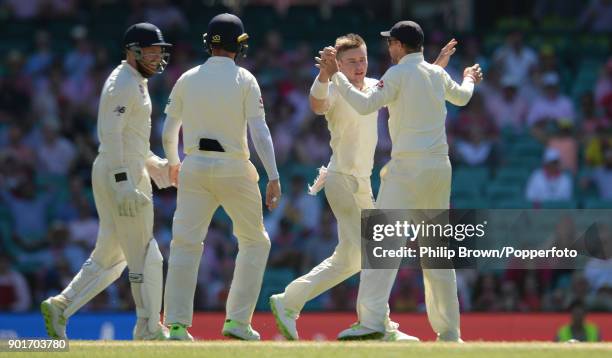 Mason Crane celebrates with Joe Root after the dismissal of Usman Khawaja of Australia during the third day of the fifth Ashes cricket test match...