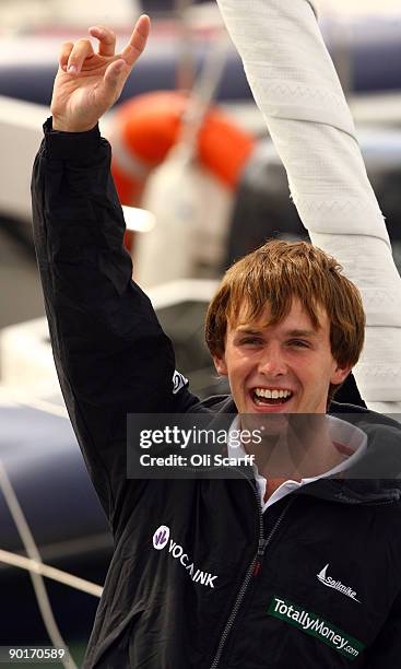 Mike Perham celebrates as he returns to Portsmouth harbour after becoming the youngest person to sail around the world solo with assistance on August...