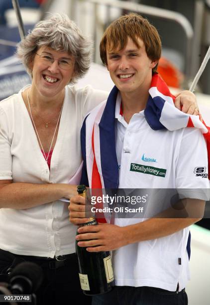Mike Perham celebrates with his mother Heather Perham as he returns to Portsmouth harbour after becoming the youngest person to sail around the world...