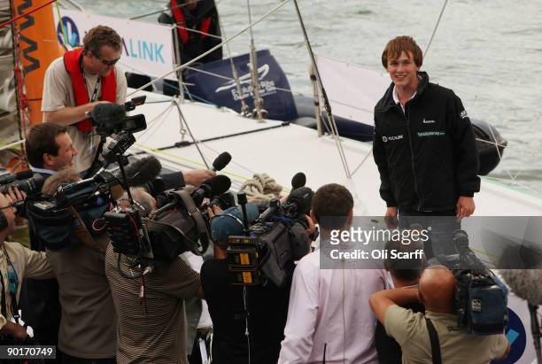 Mike Perham is interviewed by TV crews upon his return to Portsmouth harbour after becoming the youngest person to sail around the world solo with...