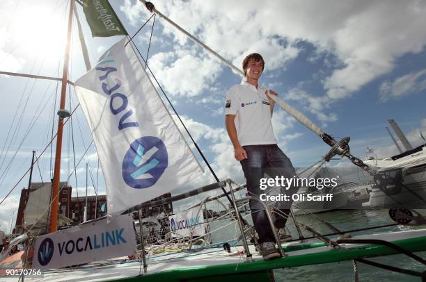 Mike Perham celebrates as he returns to Portsmouth harbour after becoming the youngest person to sail around the world solo with assistance on August...