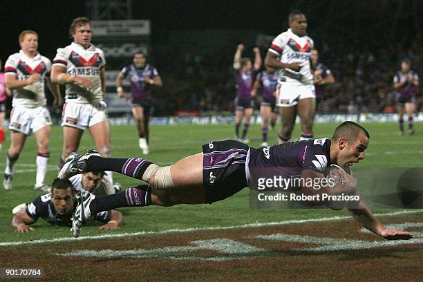 Steve Turner of the Storm scores a try during the round 25 NRL match between the Melbourne Storm and the Sydney Roosters at Olympic Park on August...