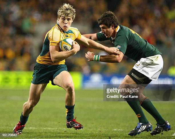 James O'Connor of the Wallabies attempts to evade a tackle by Jaque Fourie of the Springboks during the 2009 Tri Nations series match between the...