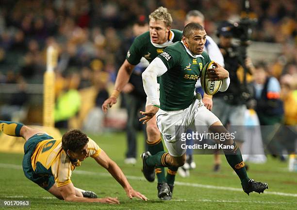 Bryan Habana of the Springboks evades a tackle by Luke Burgess of the Wallabies during the 2009 Tri Nations series match between the Australian...