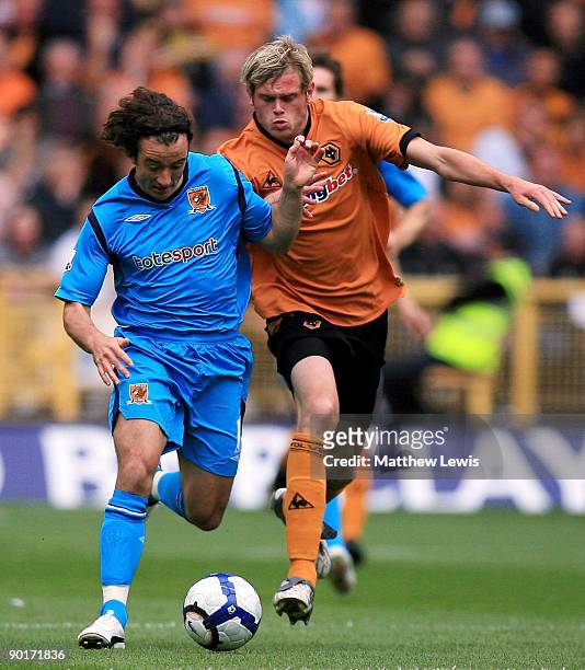 Stephen Hunt of Hull holds off Richard Stearman of Wolverhampton during the Barclays Premier League match between Wolverhampton Wanderers and Hull...