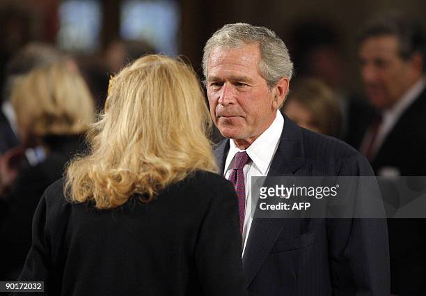 Former US President George W. Bush talks with US Senator Edward Kennedy's ex-wife Joan Kennedy as they await the start of the funeral services for US...