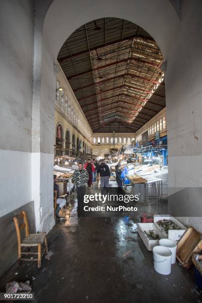 Varvakios Agora or the Central Fish Market in Athens, Greece. Seafood Stalls with fishmongers and shoppers buying fresh seafood that was catched a...