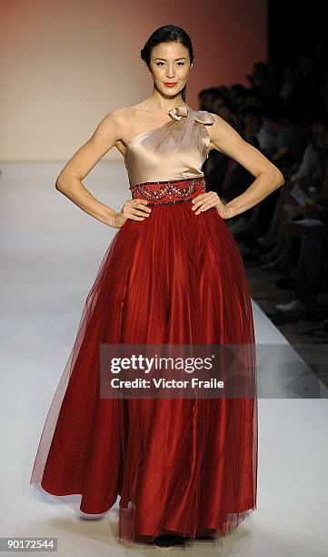 Model showcases designs by Dorian Ho on the catwalk as part of the Red Dress Collection showcase during the Mastercard Luxury Week Hong Kong 2009 at...