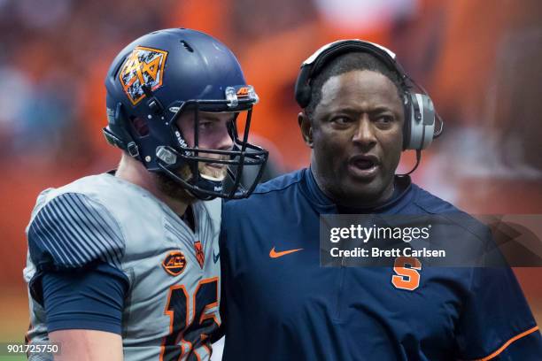 Head coach Dino Babers of the Syracuse Orange speaks with Zack Mahoney during the game against the Wake Forest Demon Deacons at the Carrier Dome on...