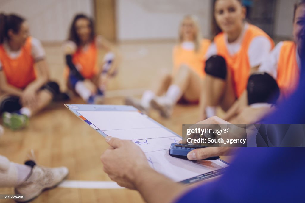 Coach talking to a volleyball players
