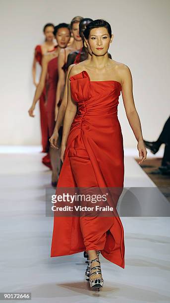 Models showcase designs on the catwalk at the end of the Red Dress Collection showcase during the Mastercard Luxury Week Hong Kong 2009 at The Four...