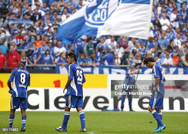 Mineiro, Carlos Zambrano and Halil Altintop of Schalke look dejected after the Bundesliga match between FC Schalke 04 and SC Freiburg at the Veltins...