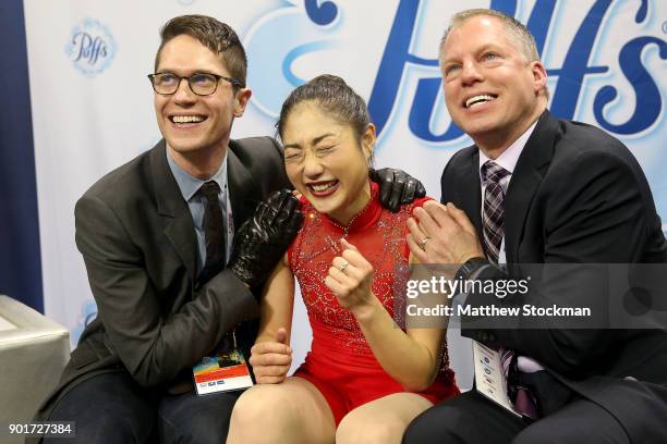 Mirai Nagasu celebrates in the kiss and cry with coaches Drew Meekins and Tom Zakrajsek after skating in the Ladies Free Skate during the 2018...