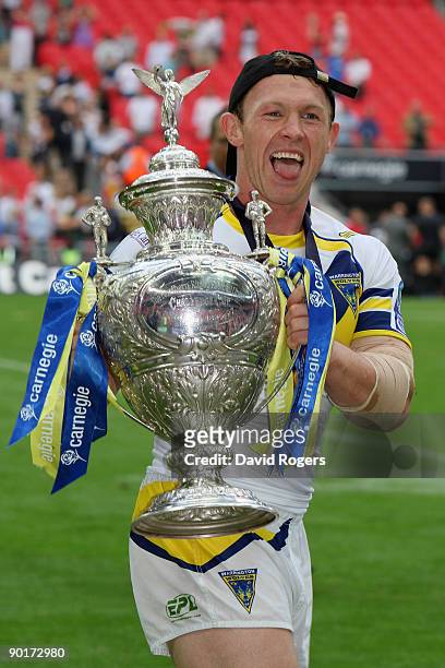 Mick Higham of Warrington celebrates with the trophy following his teams victory during the Carnegie Challenge Cup Final between Huddersfield Giants...