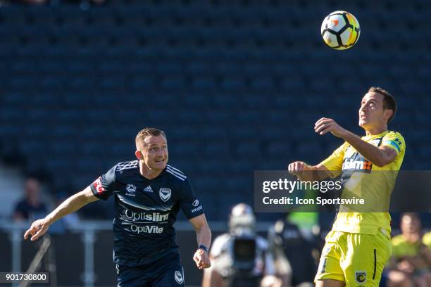 Alan Baro of the Central Coast Mariners heads the ball in front of Besart Berisha of Melbourne Victory during Round 14 of the Hyundai A-League Series...