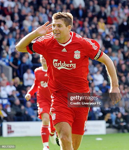 Captain of Liverpool Steven Gerrard celebrates scoring the third goal for Liverpool during the Barclays Premier League match between Bolton Wanderers...