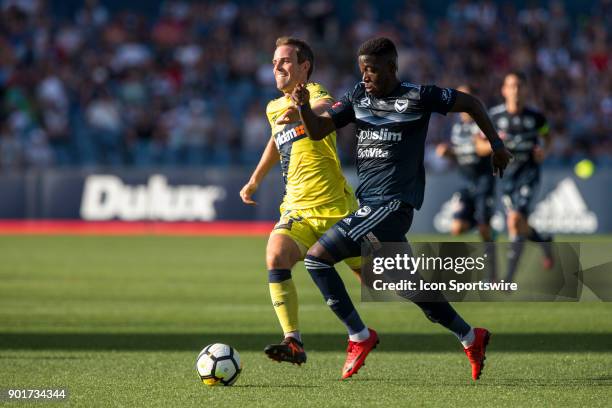 Leroy George of Melbourne Victory runs with the ball with Wout Brama of the Central Coast Mariners chasing during Round 14 of the Hyundai A-League...