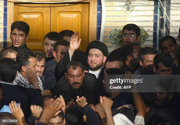 Ammar al-Hakim is surrounded by hundreds of Shiite Muslim mouners as he arrives for the burial of his father, the late Shiite Muslim leader Abdel...