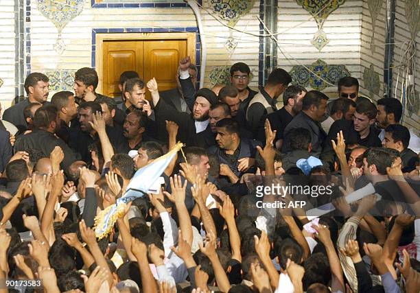Ammar al-Hakim is surrounded by hundreds of Shiite Muslim mouners as he arrives for the burial of his father, the late Shiite Muslim leader Abdel...