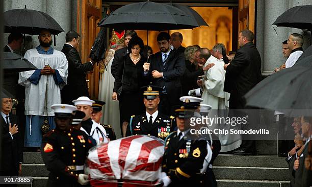 Steady rain pours down as Victoria Kennedy and her son Curran Raclin follow the casket of her husband Sen. Edward Kennedy out of Our Lady of...