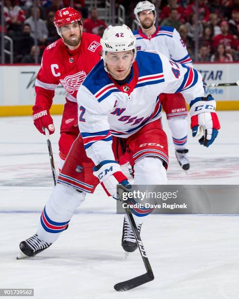 Brendan Smith of the New York Rangers skates up ice in front of Henrik Zetterberg of the Detroit Red Wings during an NHL game at Little Caesars Arena...