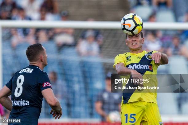 Alan Baro of the Central Coast Mariners heads the ball in front of Besart Berisha of Melbourne Victory during Round 14 of the Hyundai A-League Series...