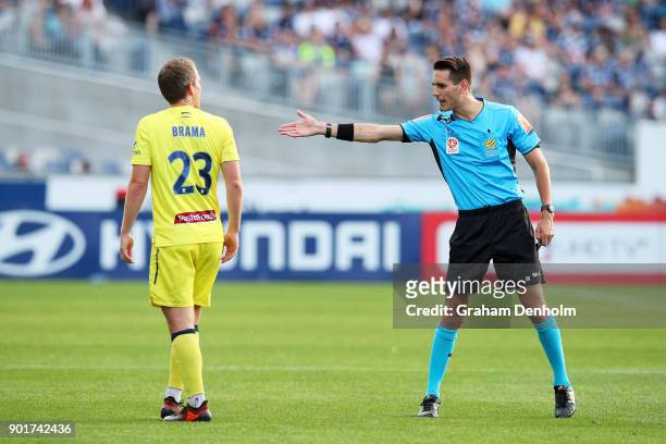 Referee Jonathan Barreiro talks to Wout Brama of the Mariners during the round 14 A-League match between the Melbourne Victory and the Central Coast...