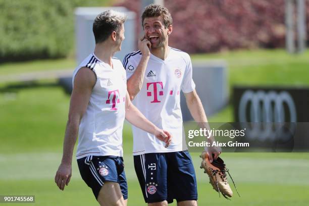 Robert Lewandowski and Thomas Mueller laugh after a training session on day 5 of the FC Bayern Muenchen training camp at ASPIRE Academy for Sports...