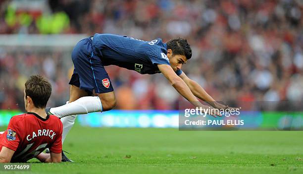Arsenal's Croatian forward Eduardo is tackled by Manchester United's English midfielder Michael Carrick during the English Premier League football...