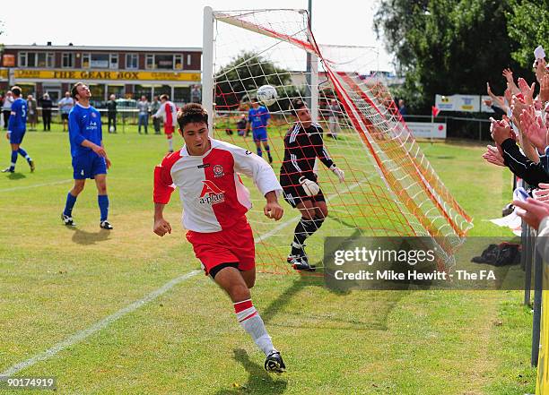 Charlie Austin of Poole Town wheels away after heading past goalkeeper Aaron Schreech of Barnstable to put his team two up during the FA Cup...