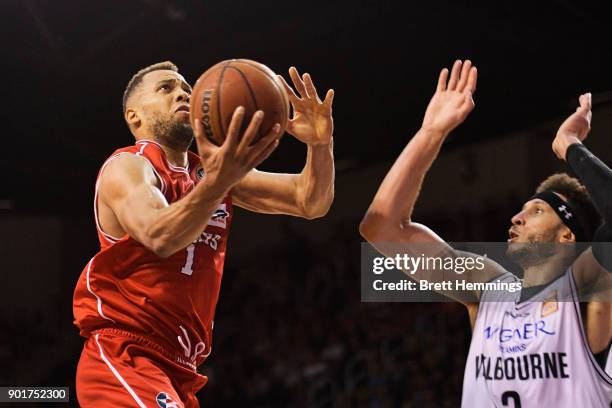 Demitrius Conger of the Hawks lays up a shot under pressure during the round 13 NBL match between the Illawarra Hawks and Melbourne United at...