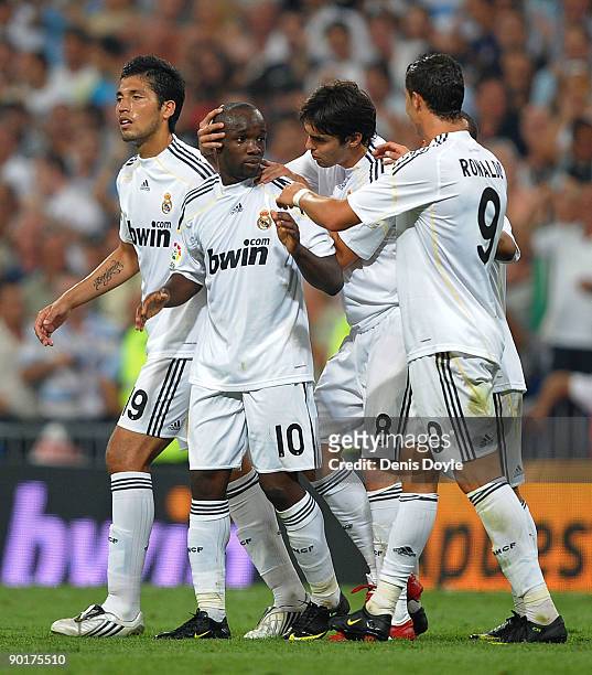 Lass Diarra of Real Madrid is congratulated by Kaka and Cristiano Ronaldo after he scored Real's third goal during the La Liga match between Real...