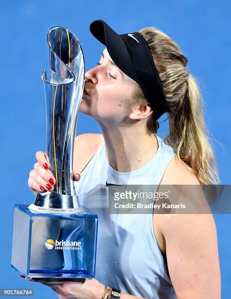 Elina Svitolina of Ukraine kisses the winners trophy as she celebrates victory after winning the Women's Final match against Aliaksandra Sasnovich of...
