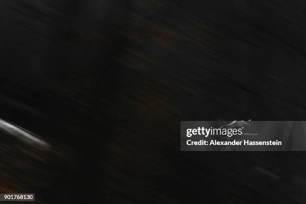 Cestimir Kozisek of Czech Republic soars through the air during his qualification jump of the FIS Nordic World Cup Four Hills Tournament on January...