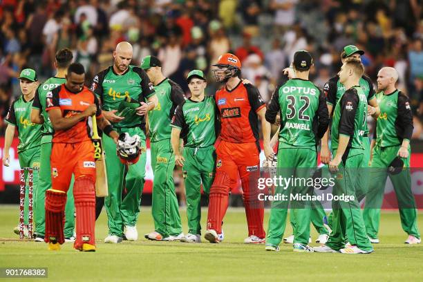 John Hastings of the Stars looks dejected after defeat as Seb Gotch of the Stars hugs Cameron White of the Renegades during the Big Bash League match...