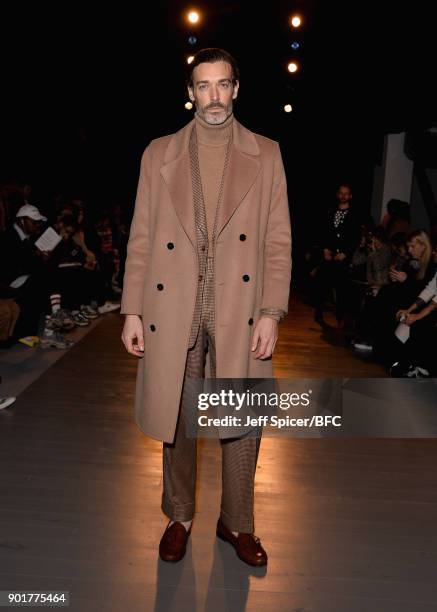 Richard Biedul poses on the front row at the John Lawrence Sullivan show during London Fashion Week Men's January 2018 at BFC Show Space on January...