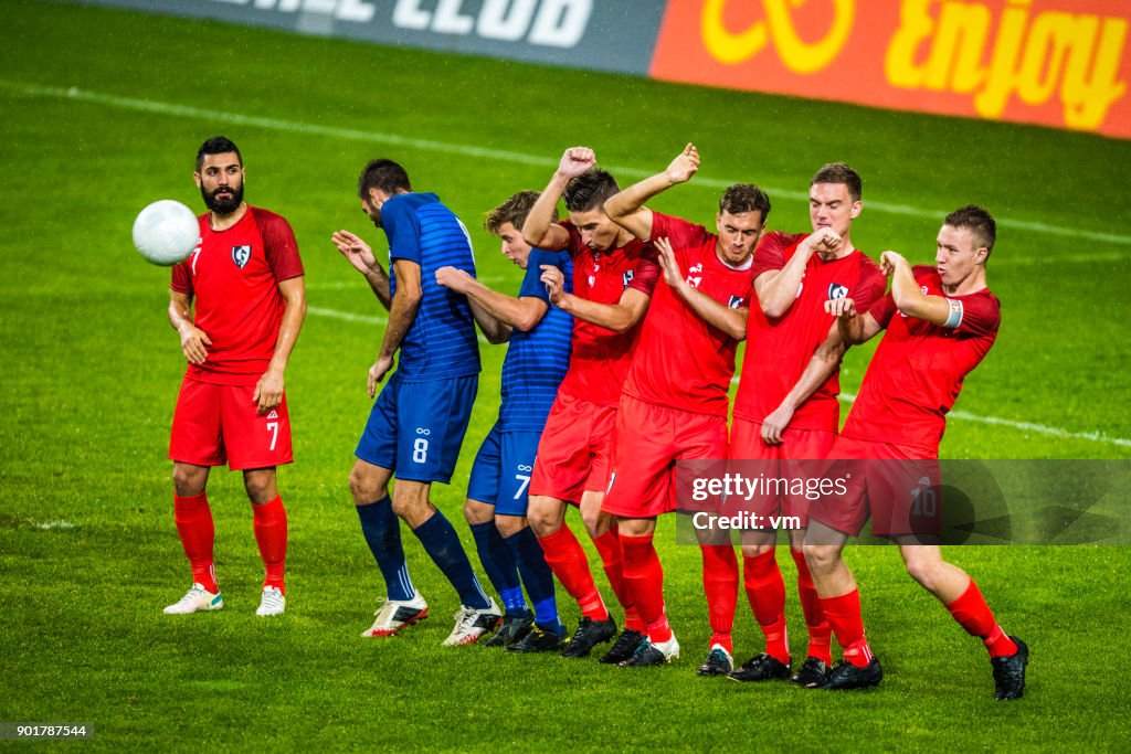 Players lined up defending from a free kick