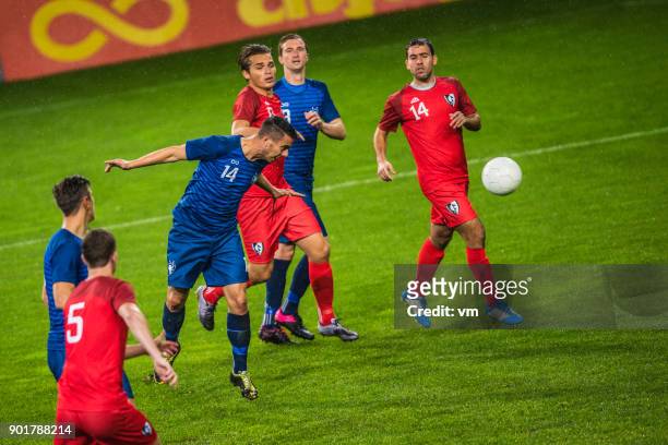 soccer player heading the ball - soccer match stock pictures, royalty-free photos & images