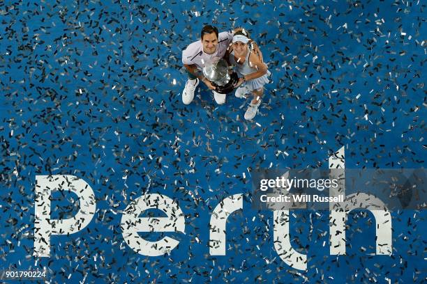 Roger Federer and Belinda Bencic of Switzerland hold the winners trophy after defeating Angelique Kerber and Alexander Zverev of Germany in the mixed...